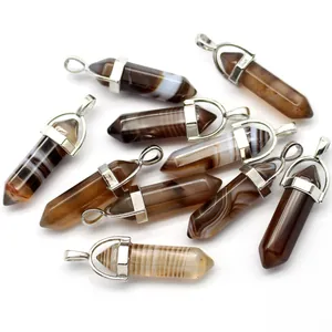 Close-up of hexagonal brown agate crystal pendants showing natural striped textures