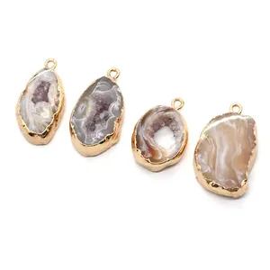 Detail of irregular natural druzy agate charms with gold plated edges and double loops