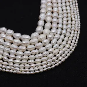 Macro detail of natural white freshwater rice pearls strands in various sizes for DIY