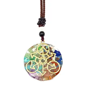 Close-up of Orgone pendant featuring colorful natural stones and golden geometric symbol