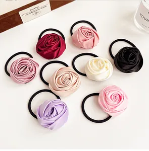 Close-up of eight assorted silk rose scrunchies showing satin texture and various colors