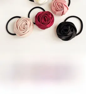Detail of rose-shaped satin hair ties in various colors with high-elasticity rubber bands