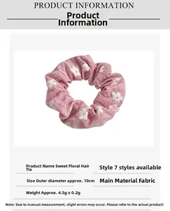 Detail view of pink floral scrunchie showing 10cm diameter size and soft fabric texture