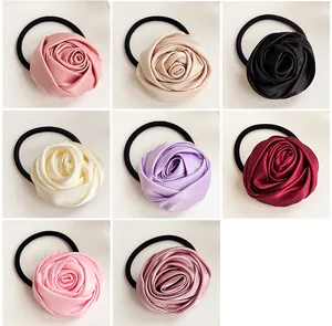 Detailed grid view showing eight colors of satin rose hair ties with elastic bands