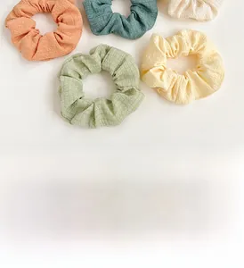 Detailed close-up of colorful scrunchies with pleated and checkered fabric textures