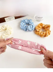 Close-up of floral scrunchies showing high elasticity and daisy print texture