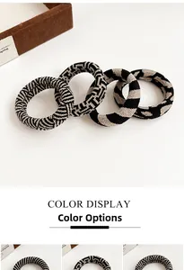 Detail view of four thick elastic hair ties in zebra, geometric, and leopard patterns