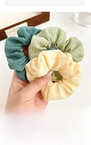 Detail of Morandi-colored scrunchies set featuring textured fabric and elastic structure