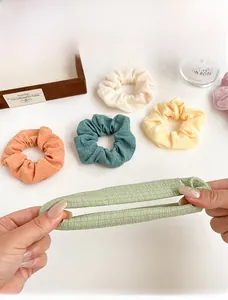 Detail display showing elastic textured fabric scrunchies in various pastel colors