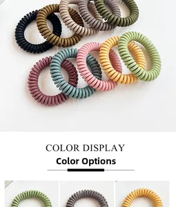Detail view of large matte spiral hair ties showing durable telephone cord texture in Morandi colors