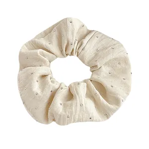 Elegant cream rhinestone scrunchie made of textured fabric for high elasticity hairstyles