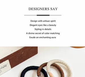Detail of woven high-elasticity hair ties in neutral tones on an elegant jewelry box