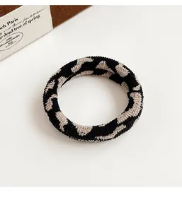 Detail view of checkerboard pattern elastic hair tie with high-quality knit texture
