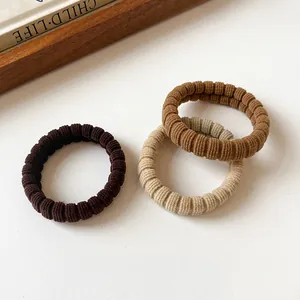 Elastic corduroy hair ties in neutral brown tones for elegant ponytail styling
