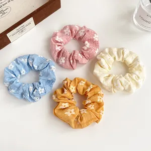 Floral print hair scrunchies set in pastel pink, blue, yellow and orange colors