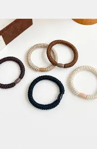 Detailed close-up of 5-piece braided high-elastic thick hair ties in earthy neutral tones