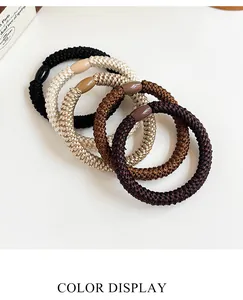 Close-up of thick braided high-elastic hair ties in neutral earth tones and textures