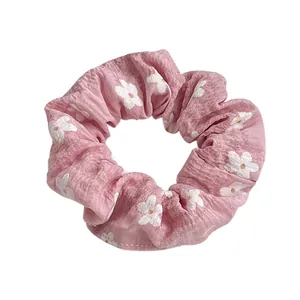 Pink floral print scrunchie with soft white flower patterns for cute girls hairstyle