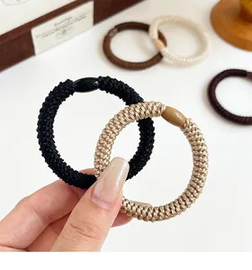 Close-up of thick high-elastic woven hair bands in coffee, black and beige earth tones