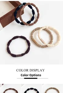 Detailed view of neutral Earth tone elastic hair ties with textured woven ribbed pattern