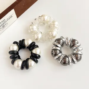Spiral pearl hair ties in transparent, black, and silver grey with elegant large beads