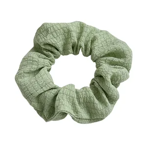 Avocado green oversized scrunchie with checkered texture fabric on white background