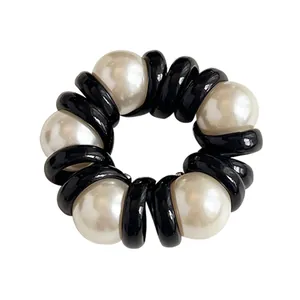 Elegant phone cord hair tie with black spiral band and white faux pearls for ponytails