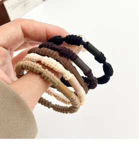 Close-up of five earth-toned high-elasticity braided hair ties in various brown shades