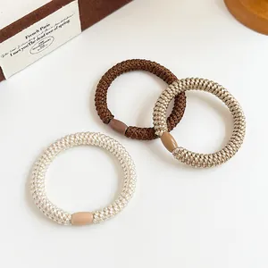 Three-pack high elasticity braided hair ties in coffee and beige tones on a clean surface