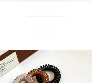 Dreiteiliges Set kleiner Spiral-Haargummis in Schwarz, Bernstein und Transparent-Grau
