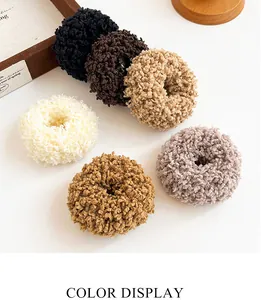 Detail view of plush teddy fleece hair ties in six neutral autumn colors on wood props