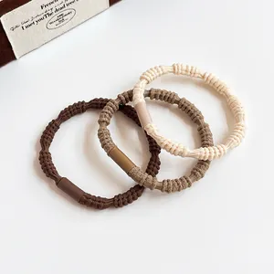 Elastic spiral hair ties set in coffee and beige colors for stylish bun hairstyles