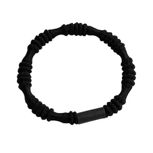 Elastic black knotted hair tie with durable spiral texture and minimalist buckle