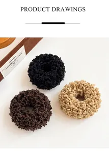 Detailed view of three plush elastic hair scrunchies in black, brown and khaki