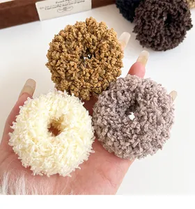 Detailed view of plush thick hair ties in beige and tan for soft autumn styling