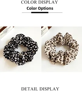 Detail display of leopard print hair scrunchies in black and coffee color options