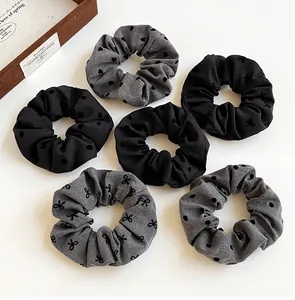 Detail view of 6-piece polka dot and heart pattern scrunchie set in black and grey