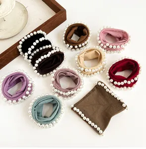 Detailed close-up of colorful pearl elastic hair ties in various elegant fabric colors