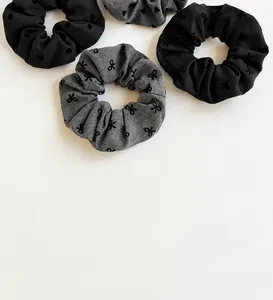 Detail of high-elasticity polka dot scrunchies with soft bow patterns and fluffy texture