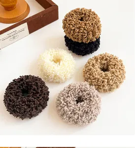 Detail shot of plush shearling hair scrunchies in six assorted earthy colors for women