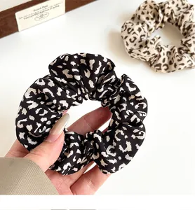 Detail of vintage leopard print scrunchies in lightweight chiffon fabric for women