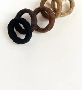Close-up of elastic ribbed towel hair ties in neutral earth tones and beige