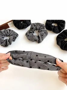 Detail view of polka dot and heart pattern scrunchies with elastic fabric texture