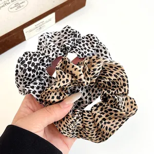 Set of two leopard print scrunchies in chiffon fabric for elegant ponytail hair styling