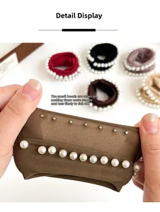 Detail showing white pearls riveted onto high elastic fabric hair scrunchies for durability