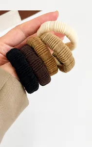 Close-up of thick seamless ribbed knit elastic hair ties in neutral earth tones