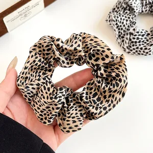 Classic leopard print silk scrunchies set in brown and white patterns for hair