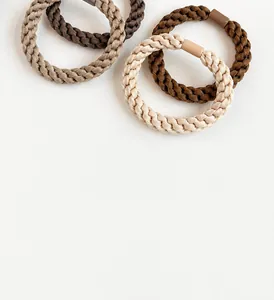 Detail of durable braided thick hair ties in coffee tones with smooth plastic connectors