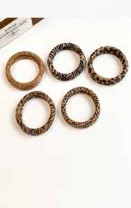 Set of five vintage leopard and tiger print hair ties on a clean white background