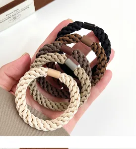 Detailed view of durable braided hair ties in five earth-toned shades with elastic texture